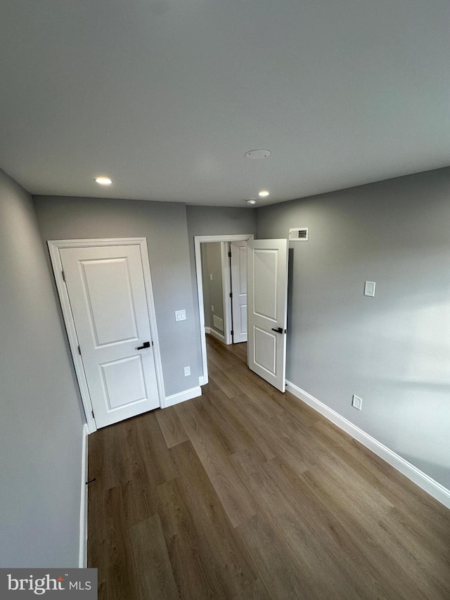 unfurnished bedroom with hardwood / wood-style floors