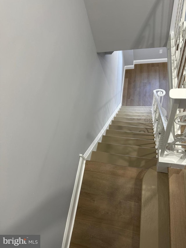 stairway with hardwood / wood-style flooring