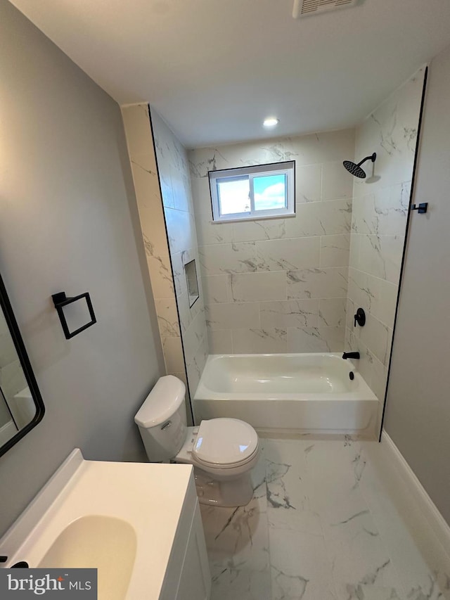 full bathroom with toilet, vanity, and tiled shower / bath