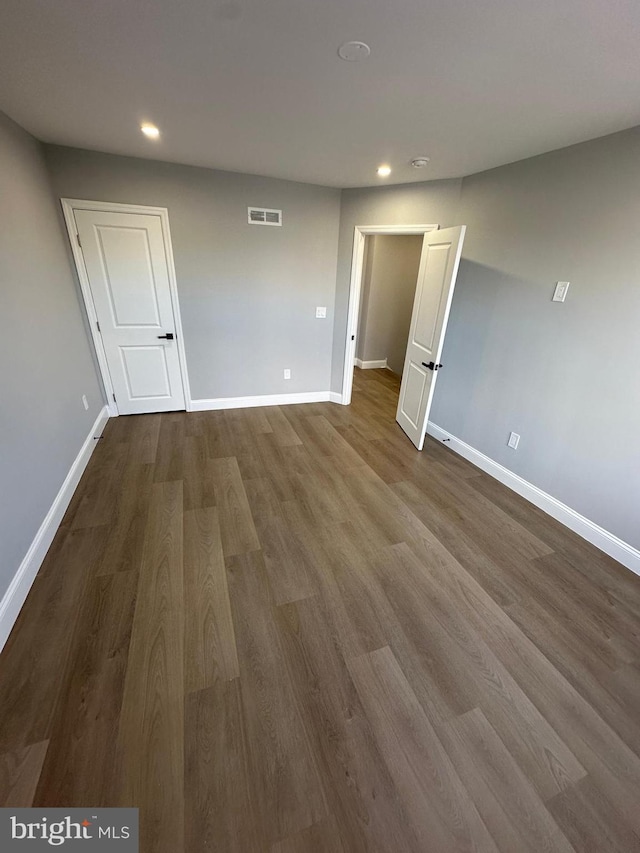 unfurnished room with hardwood / wood-style flooring