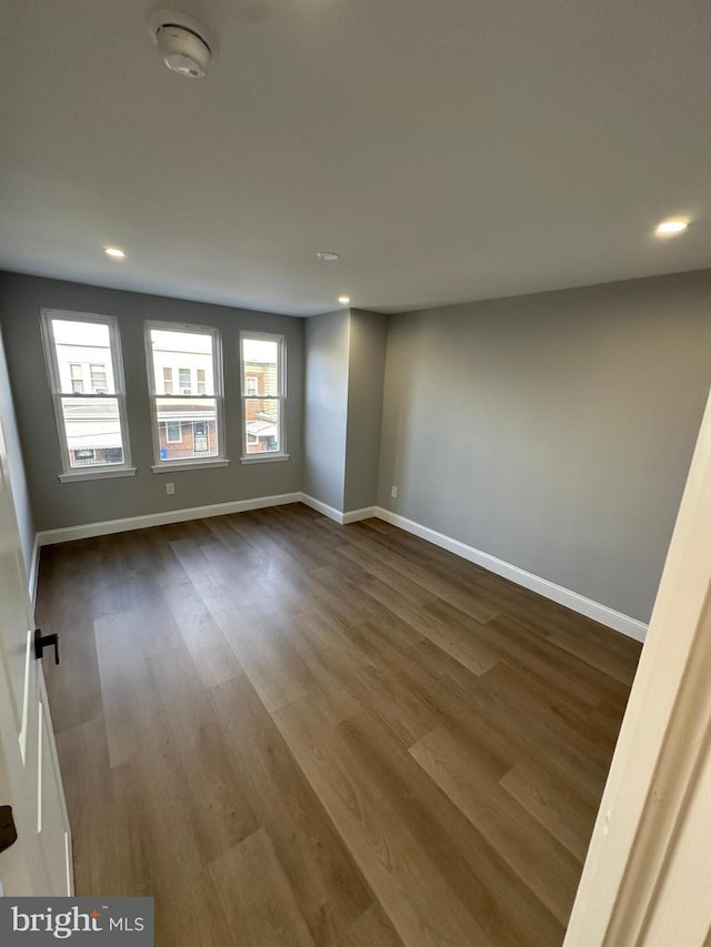 empty room with hardwood / wood-style floors