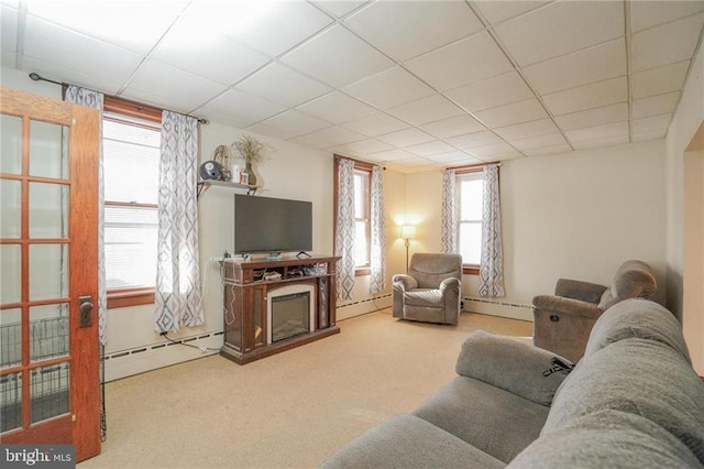 carpeted living room with a paneled ceiling, a fireplace, and baseboard heating