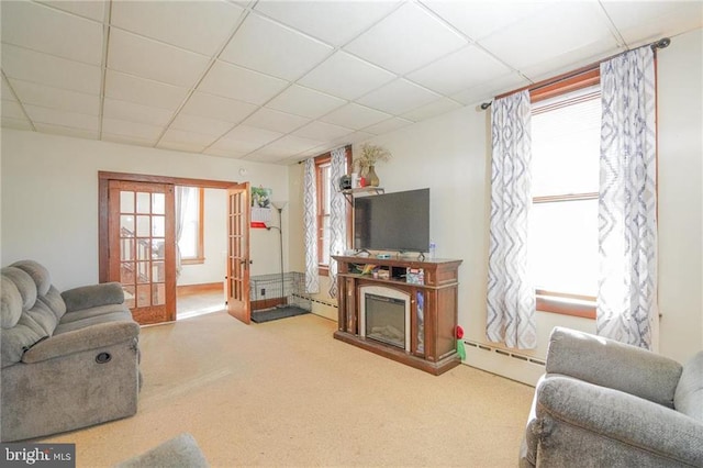 carpeted living room with french doors, a paneled ceiling, and baseboard heating