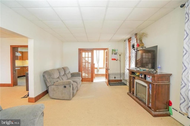 living room with a paneled ceiling, light colored carpet, baseboard heating, and french doors