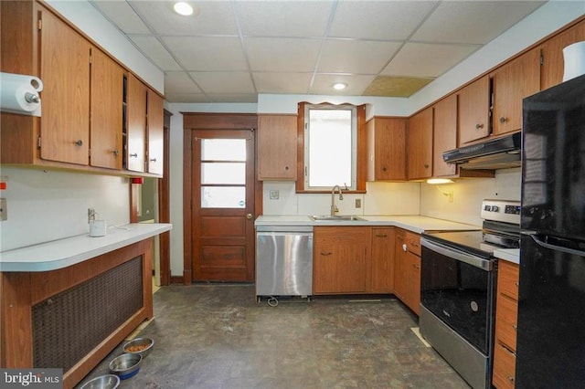 kitchen with appliances with stainless steel finishes, a paneled ceiling, and sink