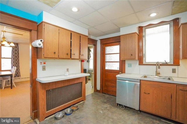 kitchen with a drop ceiling, sink, a healthy amount of sunlight, stainless steel dishwasher, and a notable chandelier