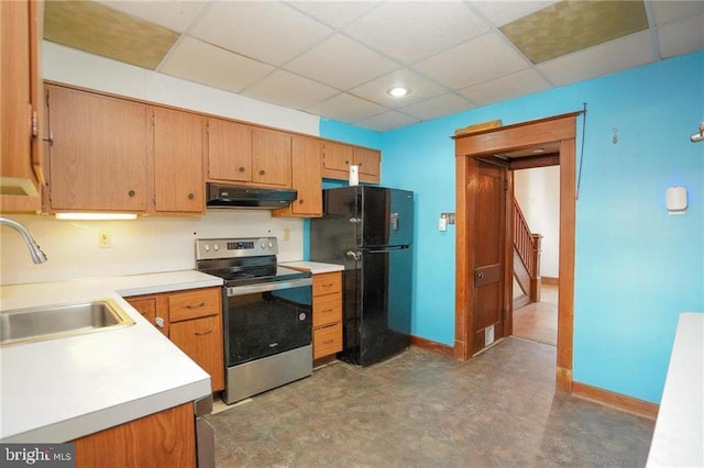 kitchen with electric range, sink, extractor fan, a paneled ceiling, and black refrigerator