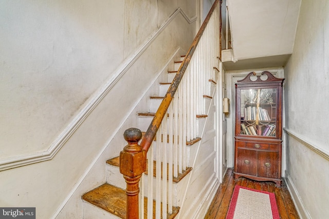 stairs featuring hardwood / wood-style floors