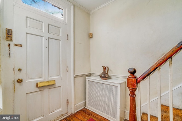 entrance foyer featuring crown molding and hardwood / wood-style floors