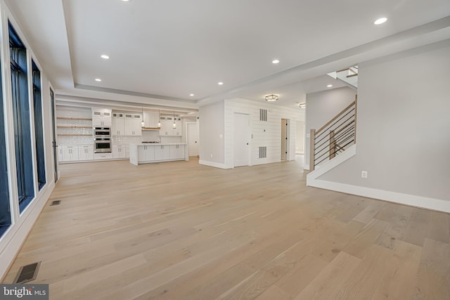 unfurnished living room with light hardwood / wood-style flooring