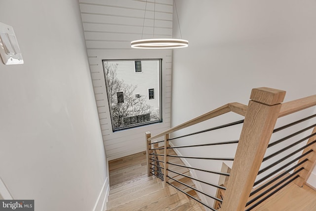 stairs with hardwood / wood-style flooring