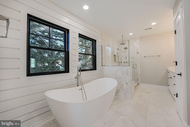 bathroom with vanity and independent shower and bath