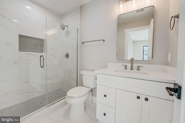 bathroom featuring vanity, a shower with door, and toilet