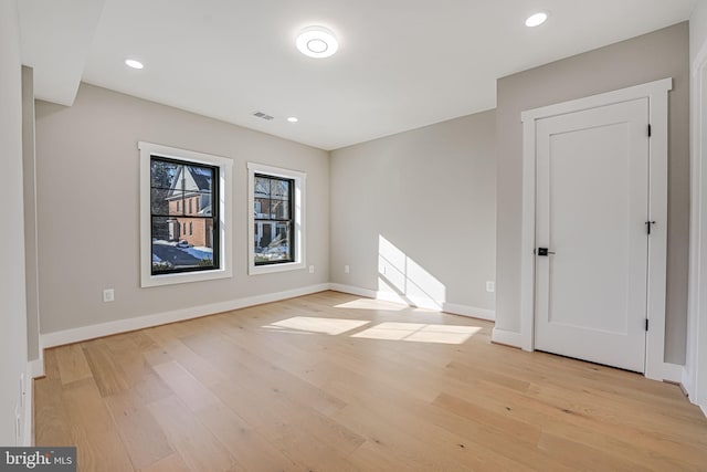empty room with light hardwood / wood-style floors
