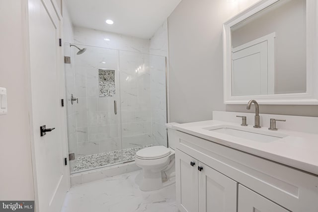 bathroom featuring an enclosed shower, vanity, and toilet