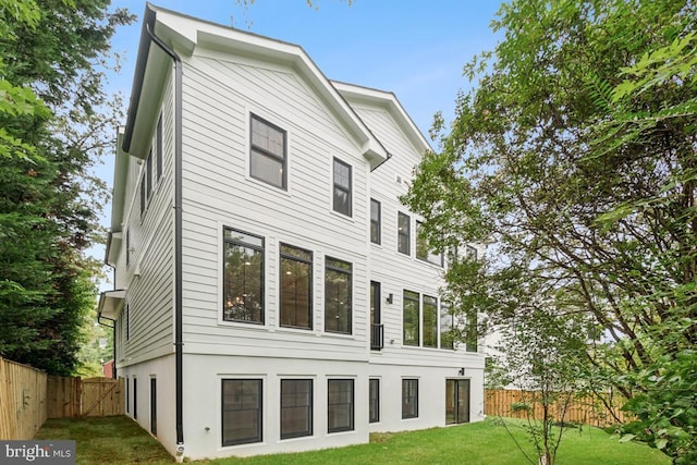 back of property with a lawn