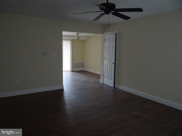 unfurnished room featuring ceiling fan and dark wood-type flooring