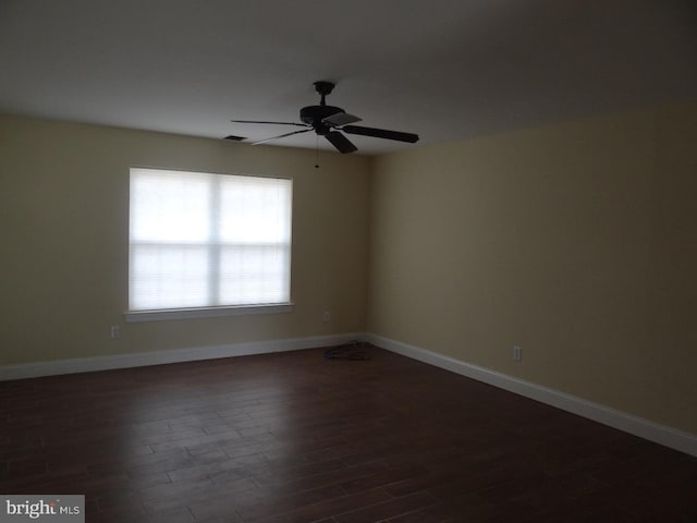 unfurnished room with ceiling fan and dark hardwood / wood-style floors