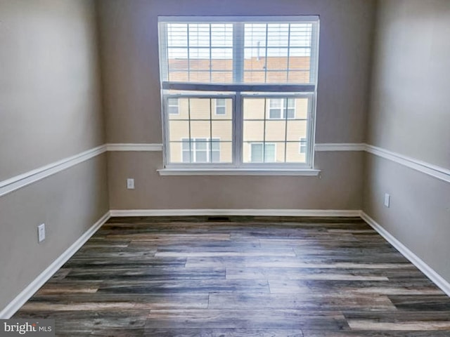 spare room with dark hardwood / wood-style floors