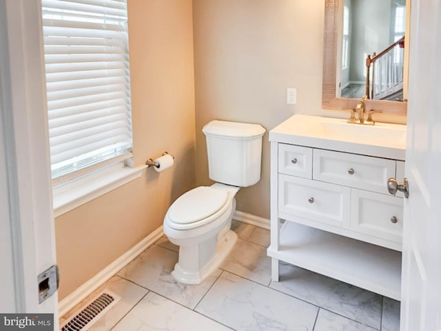 bathroom featuring vanity and toilet