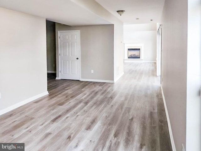 unfurnished room with light wood-type flooring