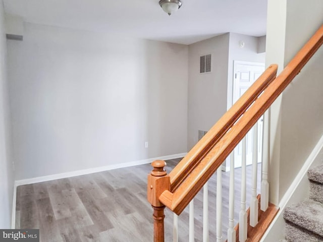 stairway featuring wood-type flooring