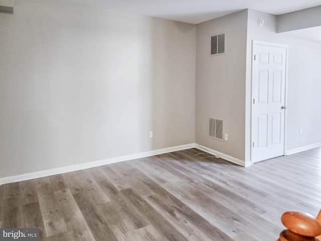 unfurnished room with hardwood / wood-style flooring