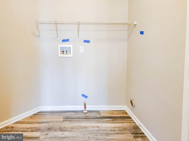 clothes washing area featuring hookup for a washing machine and hardwood / wood-style flooring