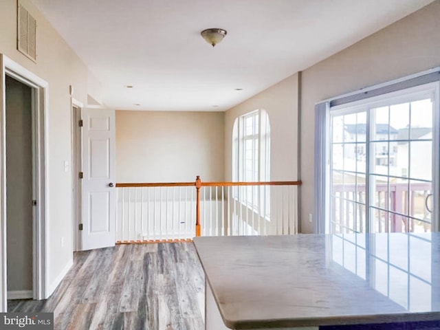 hall with hardwood / wood-style floors