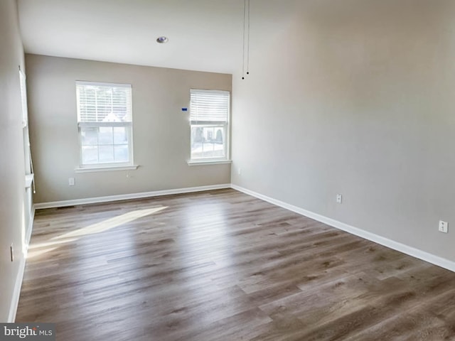 empty room featuring dark hardwood / wood-style flooring