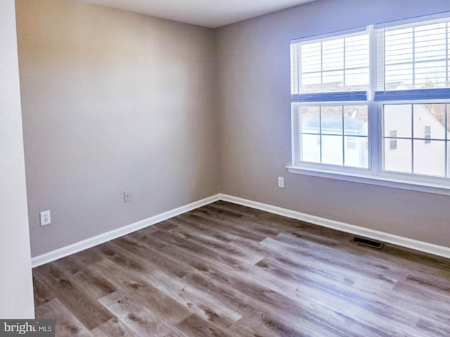 unfurnished room featuring dark hardwood / wood-style floors