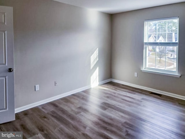 spare room featuring dark hardwood / wood-style floors