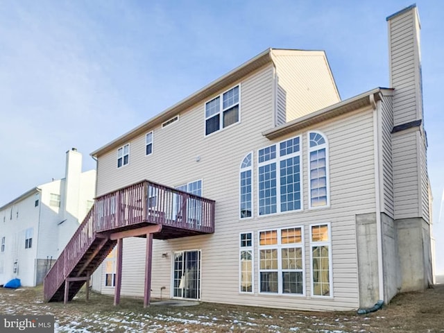 snow covered property with a wooden deck