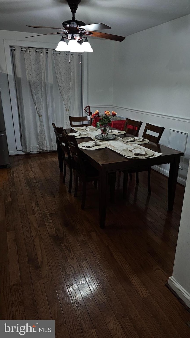 dining area featuring ceiling fan and dark hardwood / wood-style floors