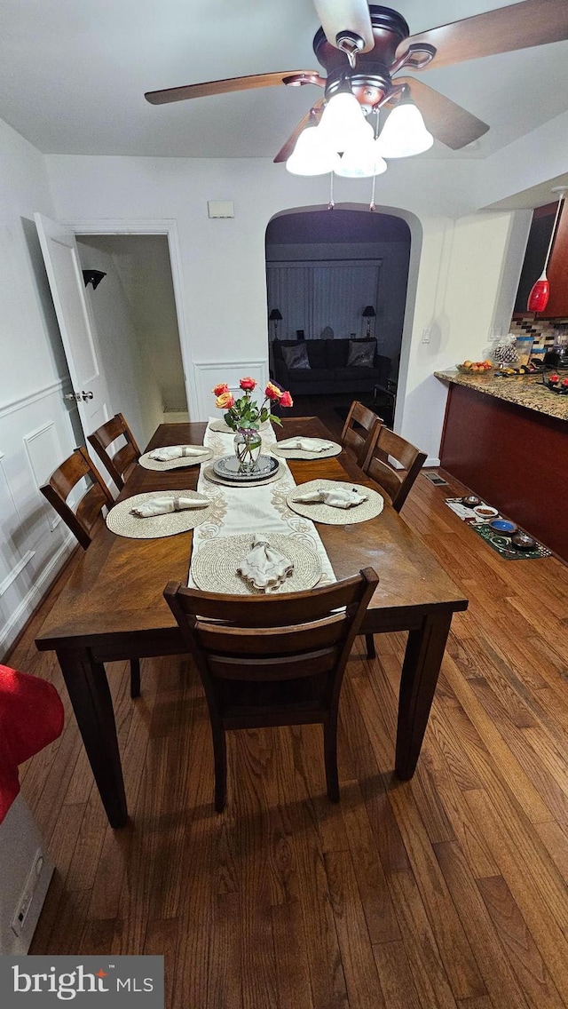 dining area with hardwood / wood-style floors and ceiling fan