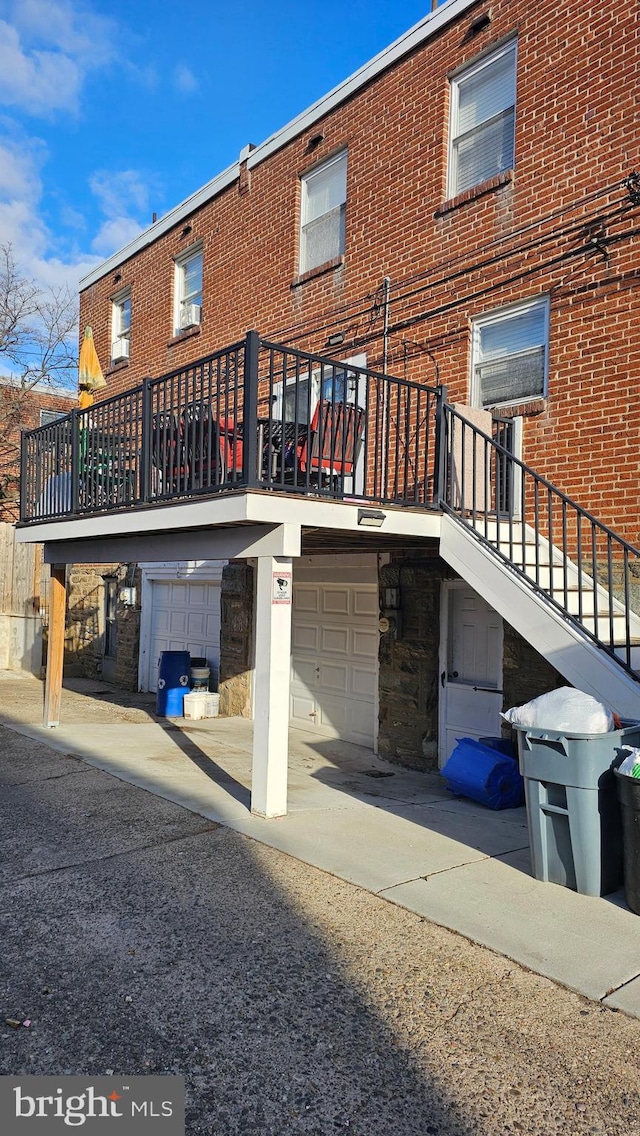 rear view of property featuring a garage