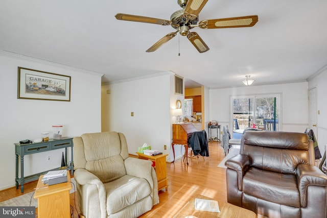 living room featuring crown molding, ceiling fan, and light hardwood / wood-style floors