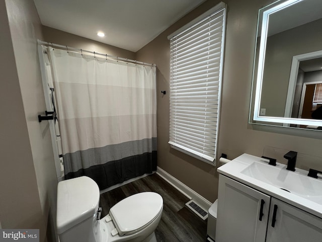 bathroom featuring vanity, curtained shower, toilet, and wood-type flooring