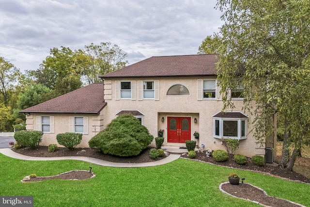 view of front of house with french doors and a front yard