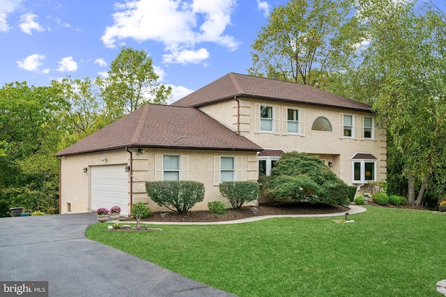 view of front of house with a garage and a front yard