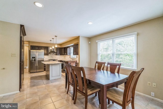 tiled dining room featuring sink