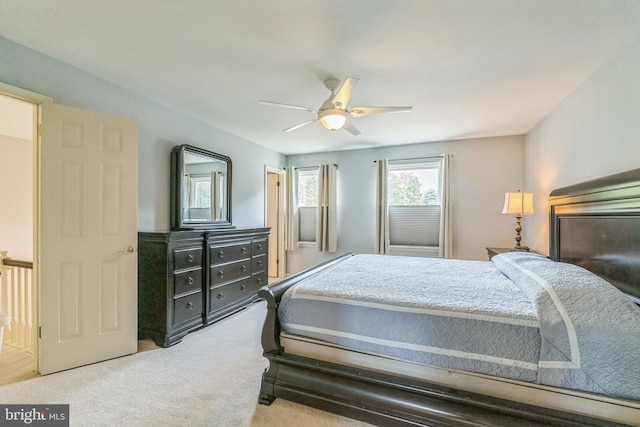 bedroom featuring light colored carpet and ceiling fan