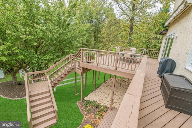 wooden deck featuring a yard