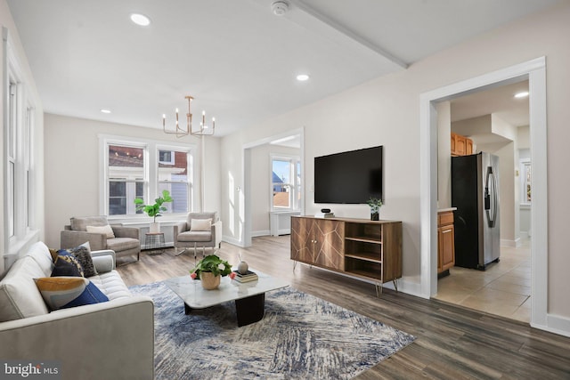 living room with light hardwood / wood-style flooring and a notable chandelier