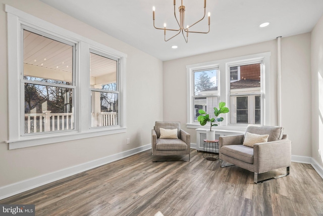 living area featuring a chandelier and hardwood / wood-style floors