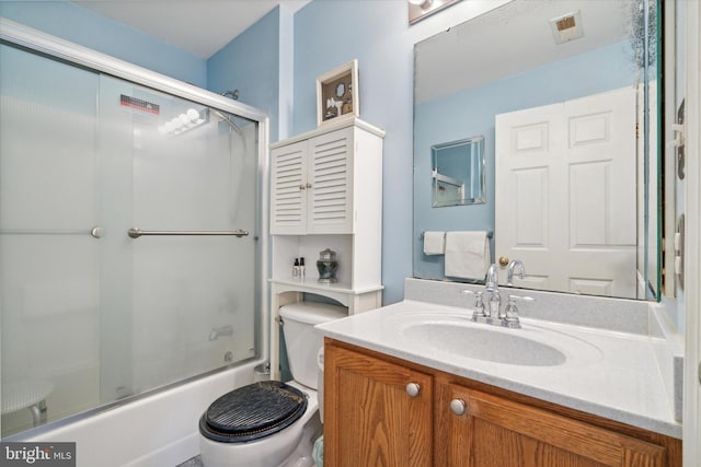 full bathroom with vanity, toilet, and enclosed tub / shower combo