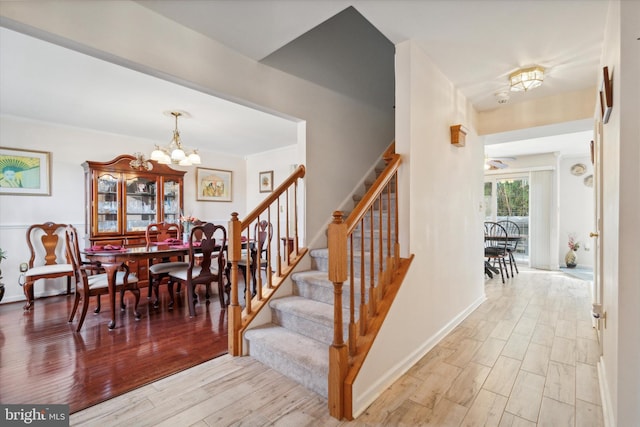 interior space featuring hardwood / wood-style flooring and ceiling fan with notable chandelier