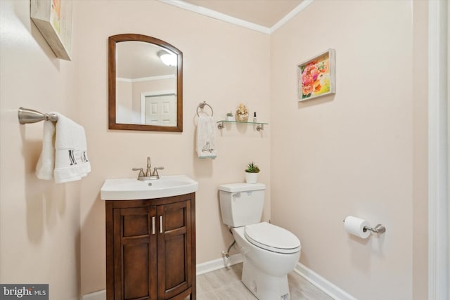 bathroom featuring crown molding, vanity, and toilet