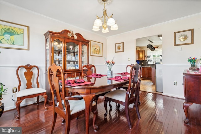 dining space featuring a chandelier, dark hardwood / wood-style floors, and ornamental molding