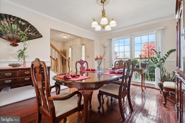 dining space featuring crown molding, a chandelier, and dark hardwood / wood-style floors